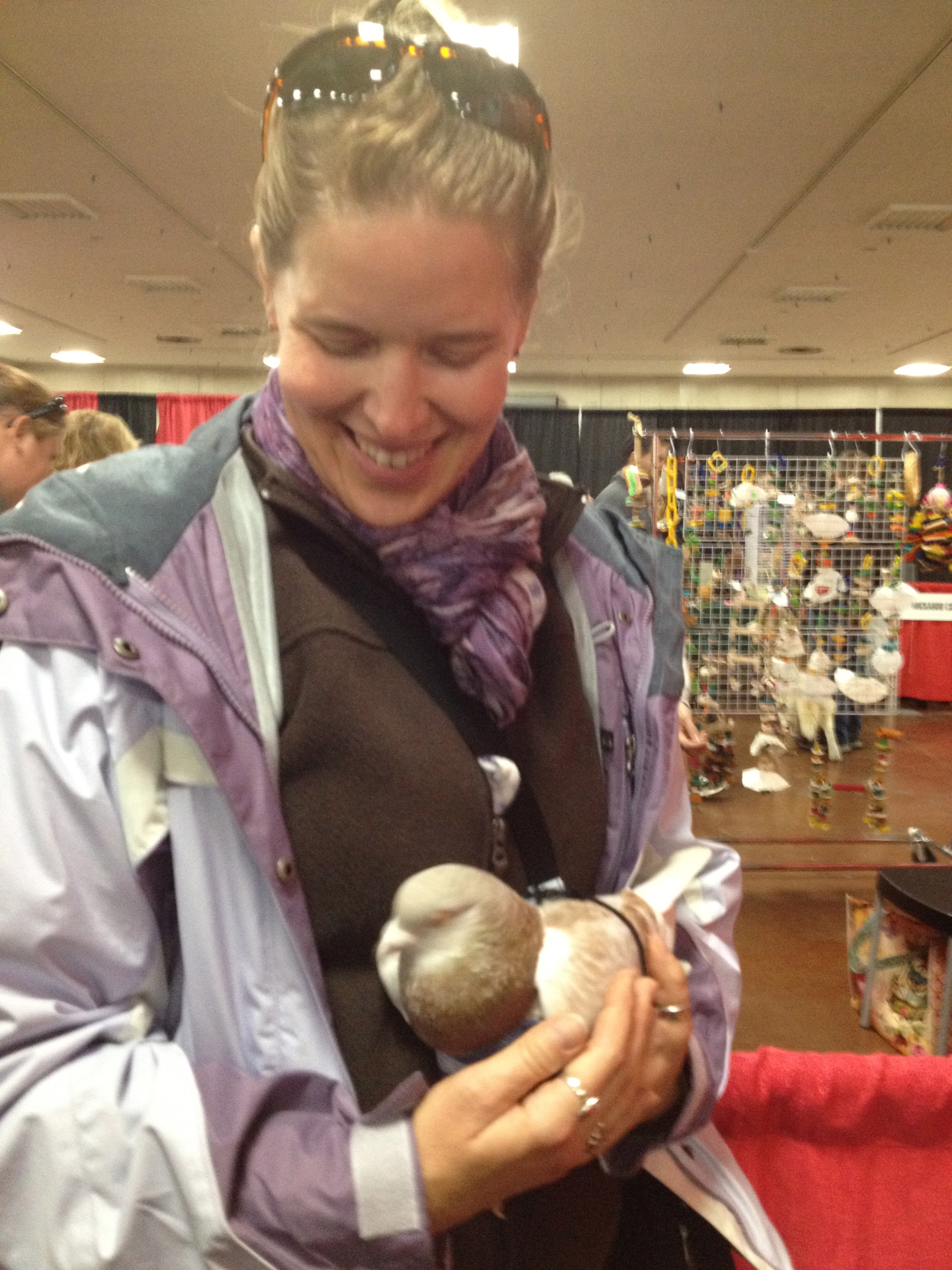 Liese holds a pigeon, Santino, for the first time