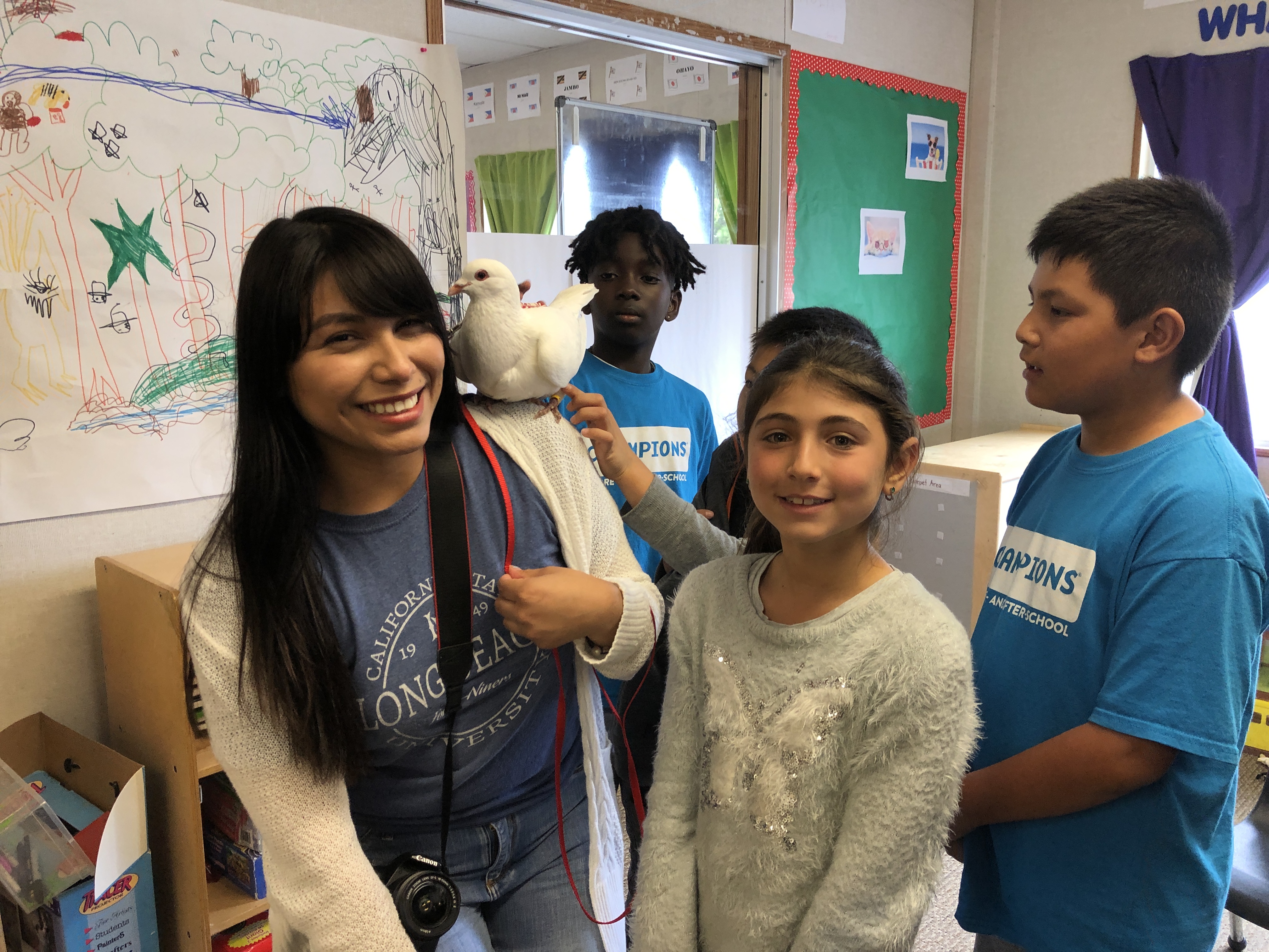 Elementary school children meeting big white rescued King pigeon Dooby