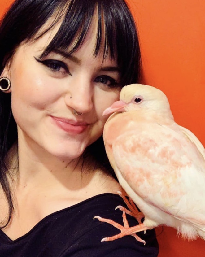 Foster volunteer with pigeon on her shoulder