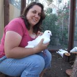 Adopter holding pigeon