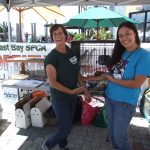 Shelter staff and volunteers showing off pigeons they brought to adoption event