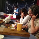 Volunteers & pigeons get on TV at KRCB's auction