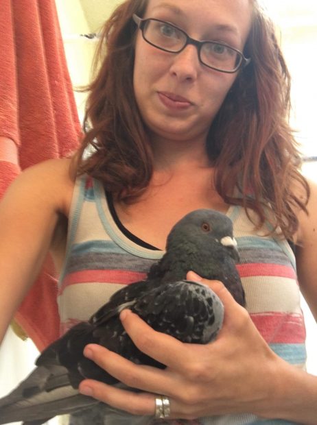 Bailey takes a selfie with one of the huge rescued pigeons 